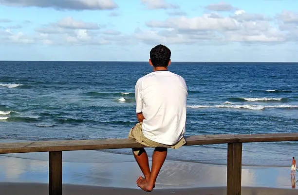 A lone man looking out to sea.