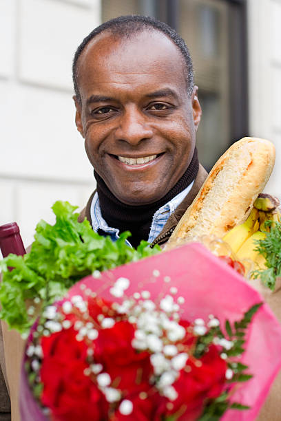 istock Happy Man with Groceries and Flowers 172672428