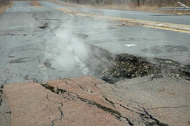 Fissure through Road "Fissure through road appears to be remanants of an earthquake, though it was actually formed by an underground mine fire." fault geology stock pictures, royalty-free photos & images