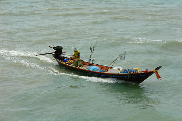 Lonely Fishing Boat in Thailand on the Sea stock photo