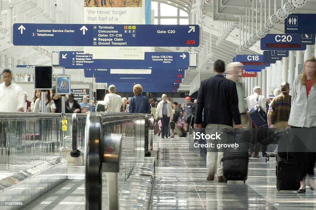 Busy airport travel day Travelers rushing through one of Chicago O'Hare airport terminals. Airport Stock Photo