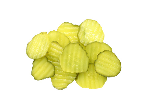 A pile of sliced dill pickles. Isolated on white.