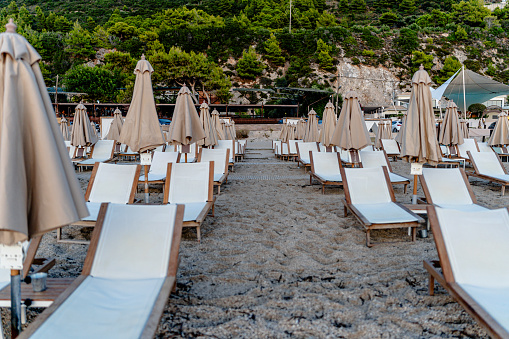 Nestled on a sandy beach, beach chairs paired with vibrant umbrellas provide the perfect refuge to enjoy the sights and sounds of the sea