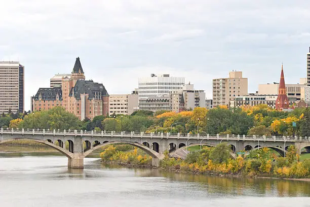 Saskatoon skyline in fall. Twenty-fifth Street Bridge visible in foreground. Hotels and apartments visible in background.