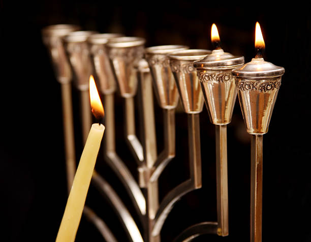 Hanukkah Menorah Lighting the menorah for Hanukkah hanukkah candles stock pictures, royalty-free photos & images