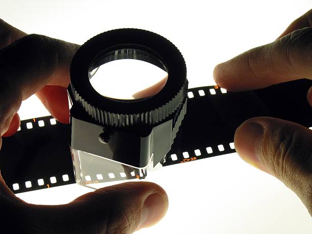 Hands holding loupe stock photo