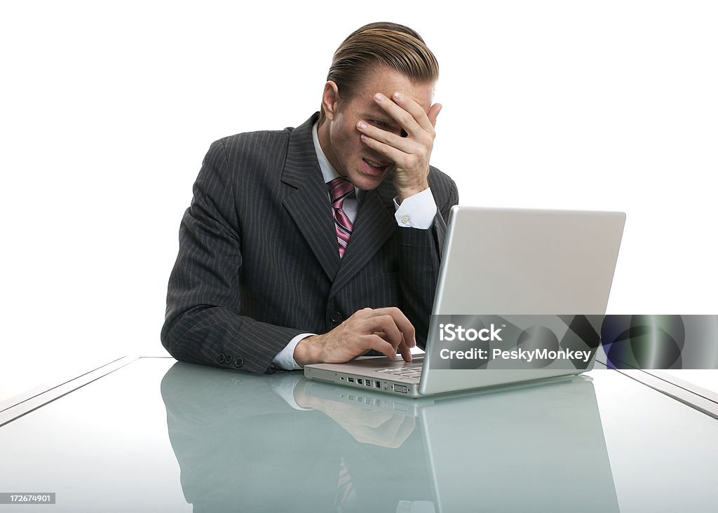 I Sent It?! Bad News Businessman Shielding Eyes at Desk Businessman shields his eyes from some bad news on his computer Accidents and Disasters Stock Photo