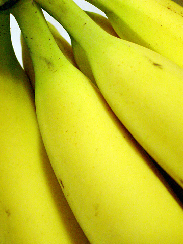 Fresh ripe banana fruit on kitchen windowsill.