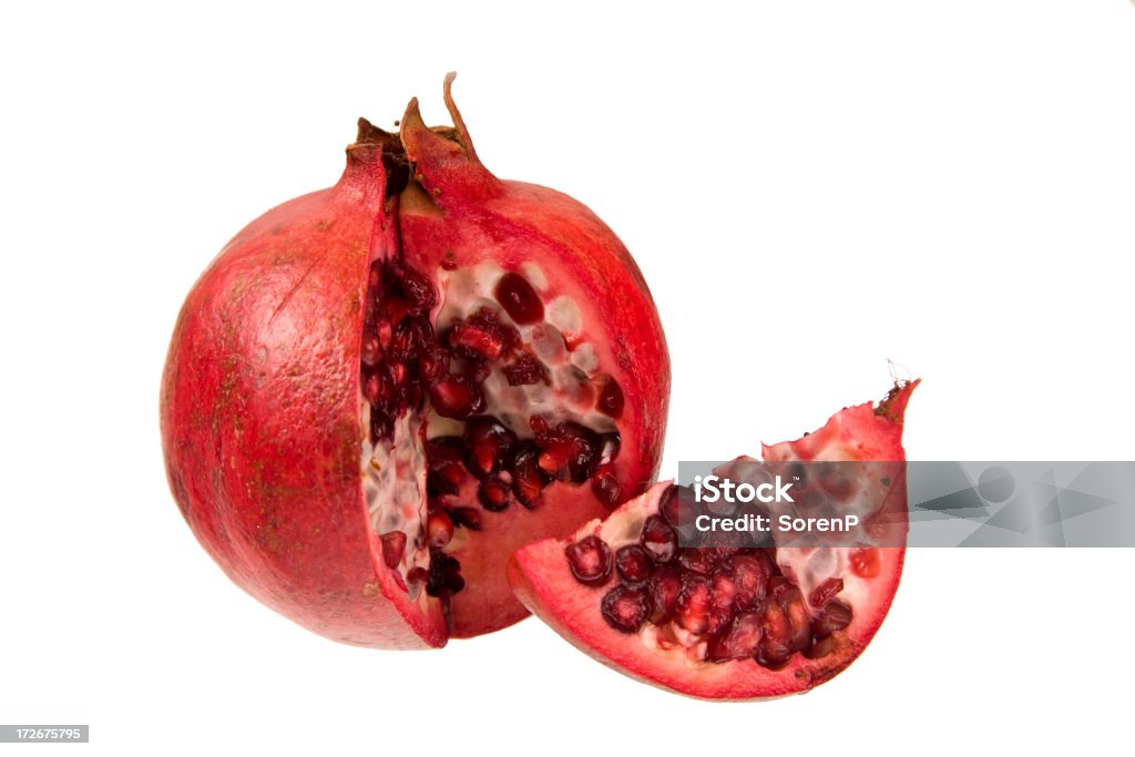 Pomegranate "Pomegranate cut open showing seeds, isolated on white" Concepts Stock Photo