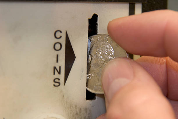 Close up of a quarter in a coin slot