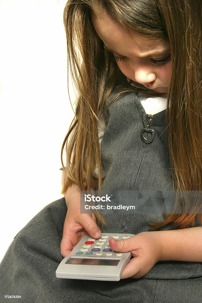 Adding things up A young student uses a calculator Adult Stock Photo