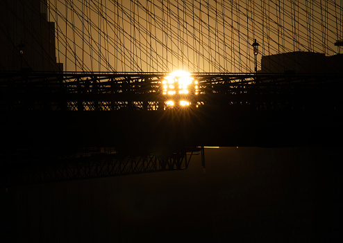 Sun setting behind the Brooklyn Bridge
