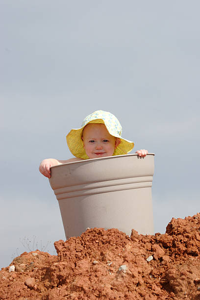 Child in Bucket Cute shot of Emma in a bucket. The mother wanted this shot for a birthday card she was creating. left handed catcher stock pictures, royalty-free photos & images