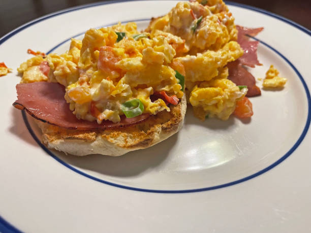 istock Scrambled Eggs and Ham Over English Muffin 1726770359