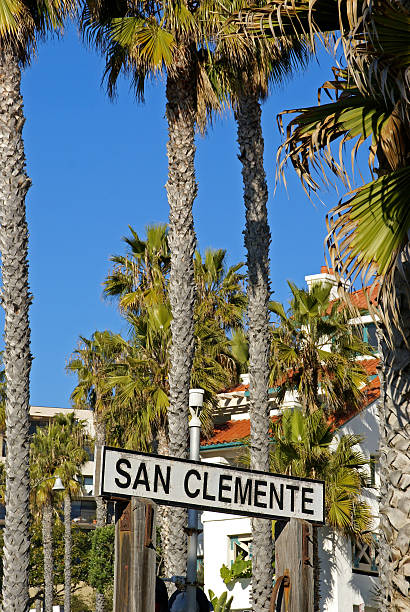 San Clemente Sign A well known sign in the coastal city of San Clemente, California, with tall palm trees and blue sky background. san clemente california stock pictures, royalty-free photos & images