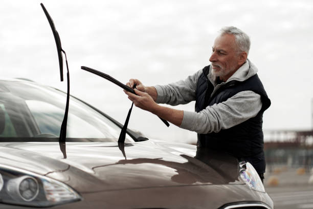istock Senior man driver installing new windscreen wipers. Car maintenance and Safety driving concept 1726781646