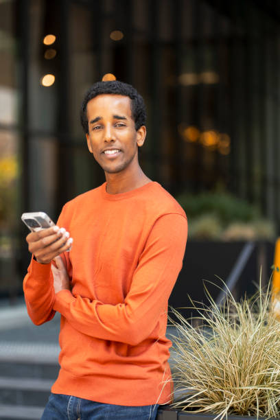 istock Smiling African American man businessman holding mobile phone, checking mail looking at camera 1726801209