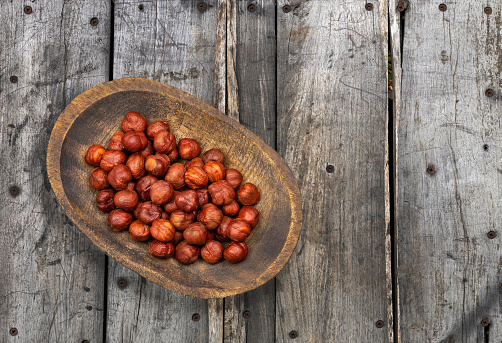 Hazelnut nuts in the wooden bowl - Corylus avellana