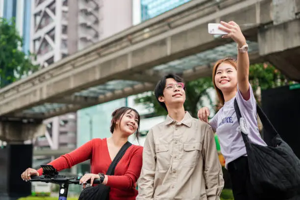 Young asian people taking selfie in the city