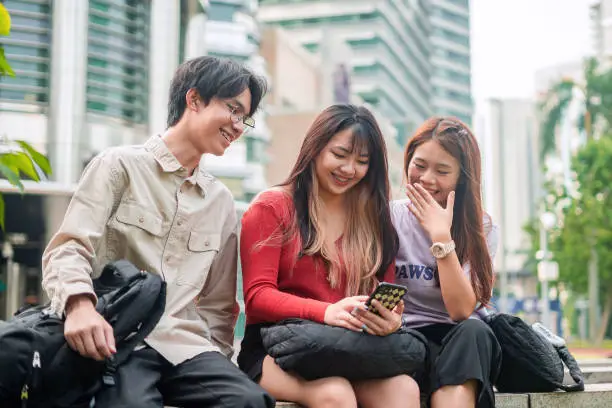 Young asian people using smartphone in the city