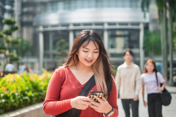 istock Young asian woman using smartphone in the city 1726818123