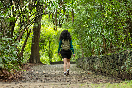 Young woman with backpack in the middle of nature
