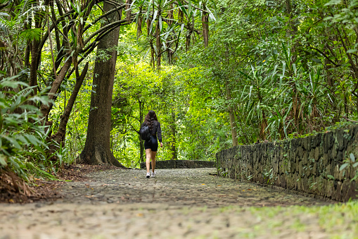 Young woman walking far away in the wilderness