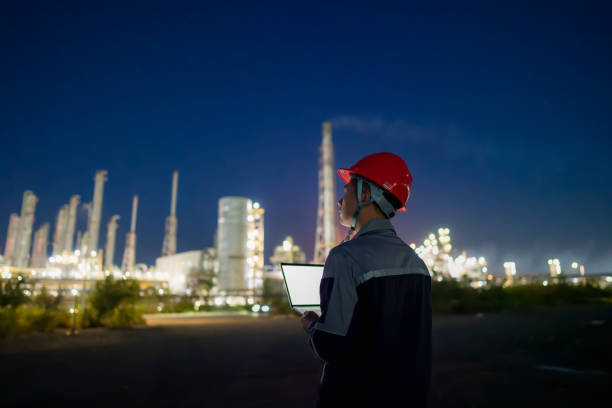istock Chemical plant engineer using laptop at night 1726842223