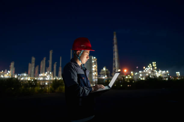 istock Chemical plant engineer using laptop at night 1726842234