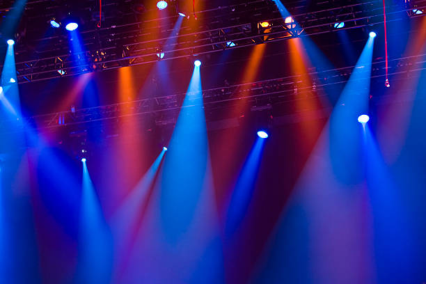 Red and blue lighting attached to a metal row in a concert stock photo