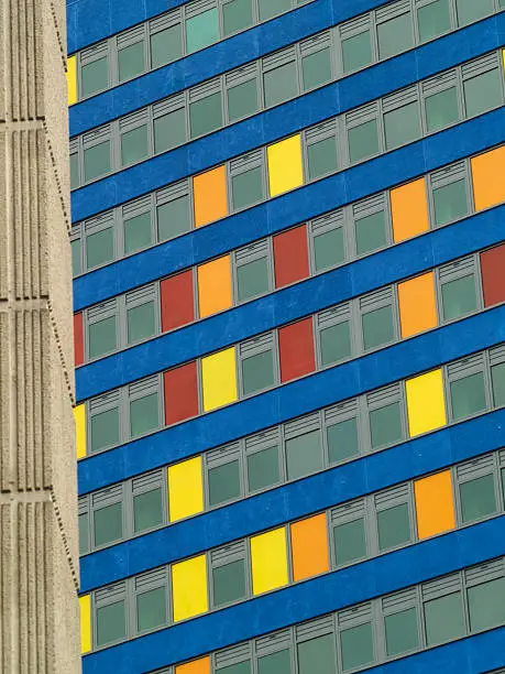 A city-centre office building with multi-coloured panels