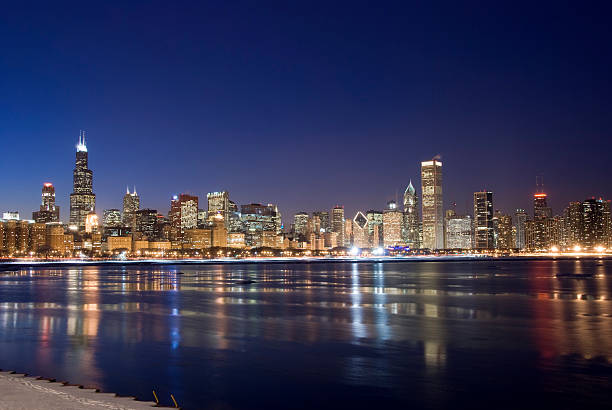 Wide View of Chicago Skyline at Night The Chicago skyline at twilight on a cold night.  As seen from across Lake Michigan. aon center chicago photos stock pictures, royalty-free photos & images