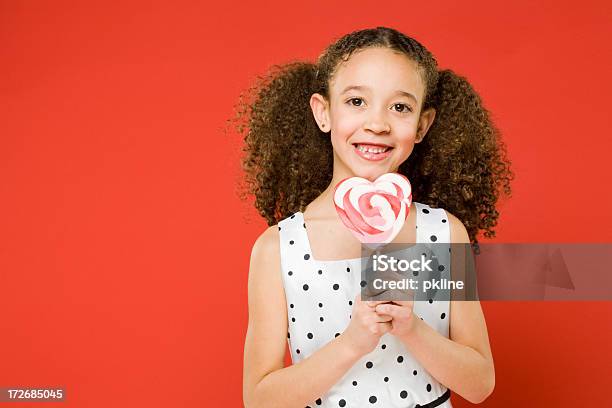 Happy Little Girl Holds Lollipop Stock Photo - Download Image Now - 10-11 Years, Black Color, Child