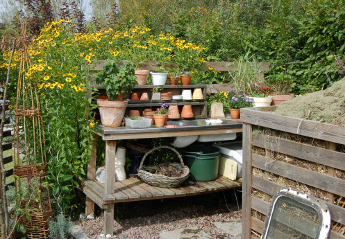Planting Table/Gardener Work Bench with pots and plants and a compostYou might also like