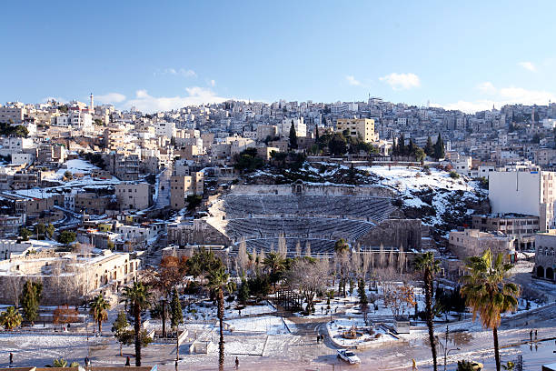 Ancient Roman theater exterior from a public square in Amman downtown. Panoramic wide view on a sunny day in Jordanian capital city and one of the biggest landmarks of Jordan