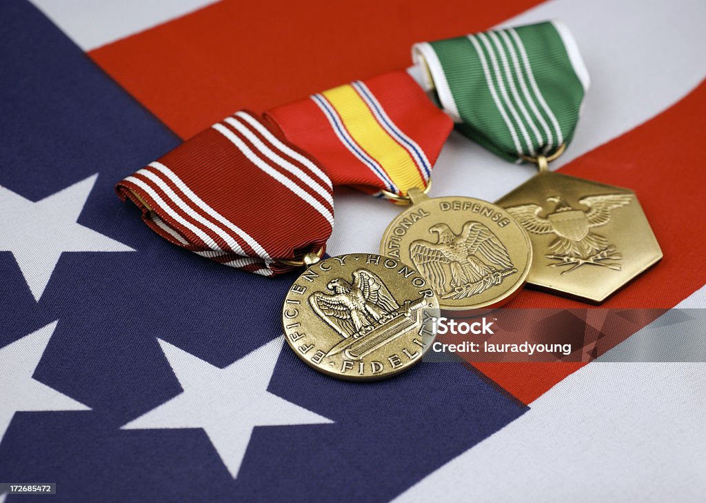 U.S. Army Medals with American Flag Background "United States Army Good Conduct Medal, National Defense Medal and Army Commendation Medal with American Flag background." Achievement Stock Photo