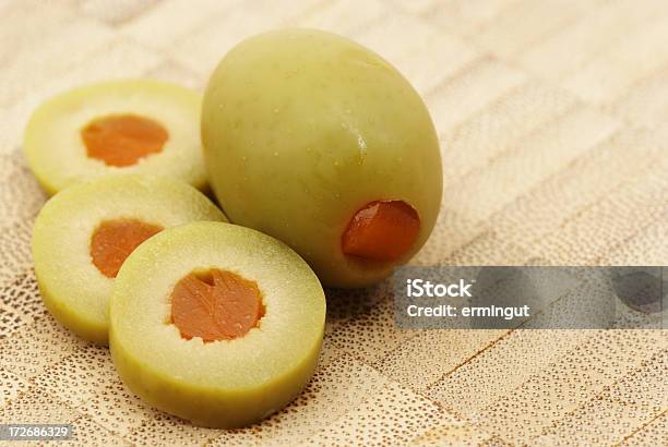 Sliced And Whole Stuffed Olive On Wooden Plate Stock Photo - Download Image Now - Chopped Food, Close-up, Copy Space