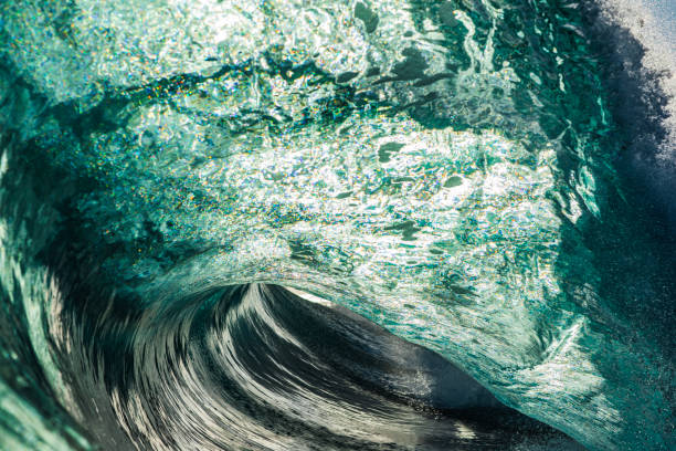 istock Close up of powerful backlit ocean wave breaking in bright golden morning light 1726865938