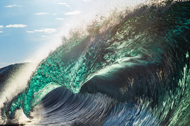 istock Backlit ocean wave breaking in bright golden morning light 1726865952