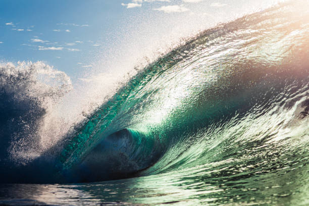 istock Backlit ocean wave breaking in bright golden morning light 1726866488