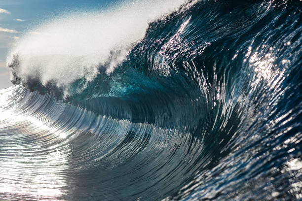 istock Perfect blue ocean wave breaking in bright morning light 1726867019