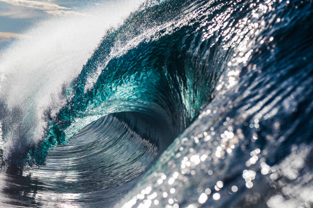 istock Perfect blue ocean wave breaking in bright morning light 1726867533