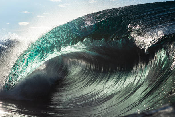 istock Powerful large blue ocean wave breaking in bright morning light 1726868076