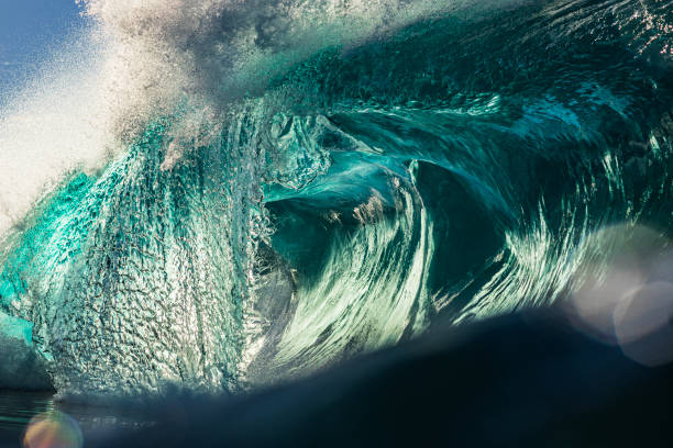 istock Light refractions on surface of large abstract ocean wave breaking in bright morning sunlight 1726873822