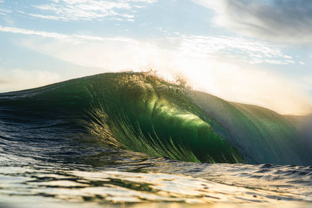 istock Backlit ocean wave breaking in bright golden morning light 1726875939