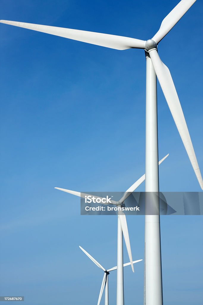 Three mighty windmills in a row Three mighty windmills in a row against a blue sky. Wind Turbine Stock Photo