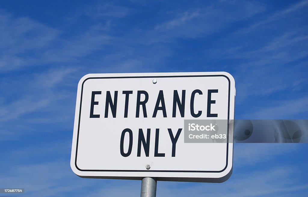 Entrance Only Sign Entrance Only sign against blue sky. Black Color Stock Photo