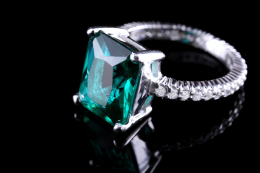 beautiful white gold ring with diamonds and aquamarine on a black background close-up
