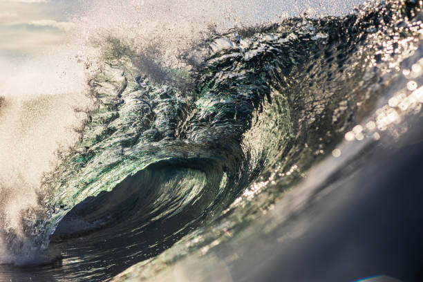 istock Backlit ocean wave breaking in bright golden morning light 1726882287
