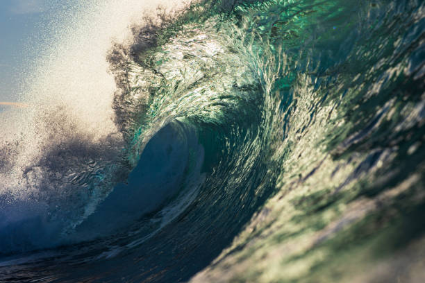 istock Backlit ocean wave breaking in bright golden morning light 1726882295